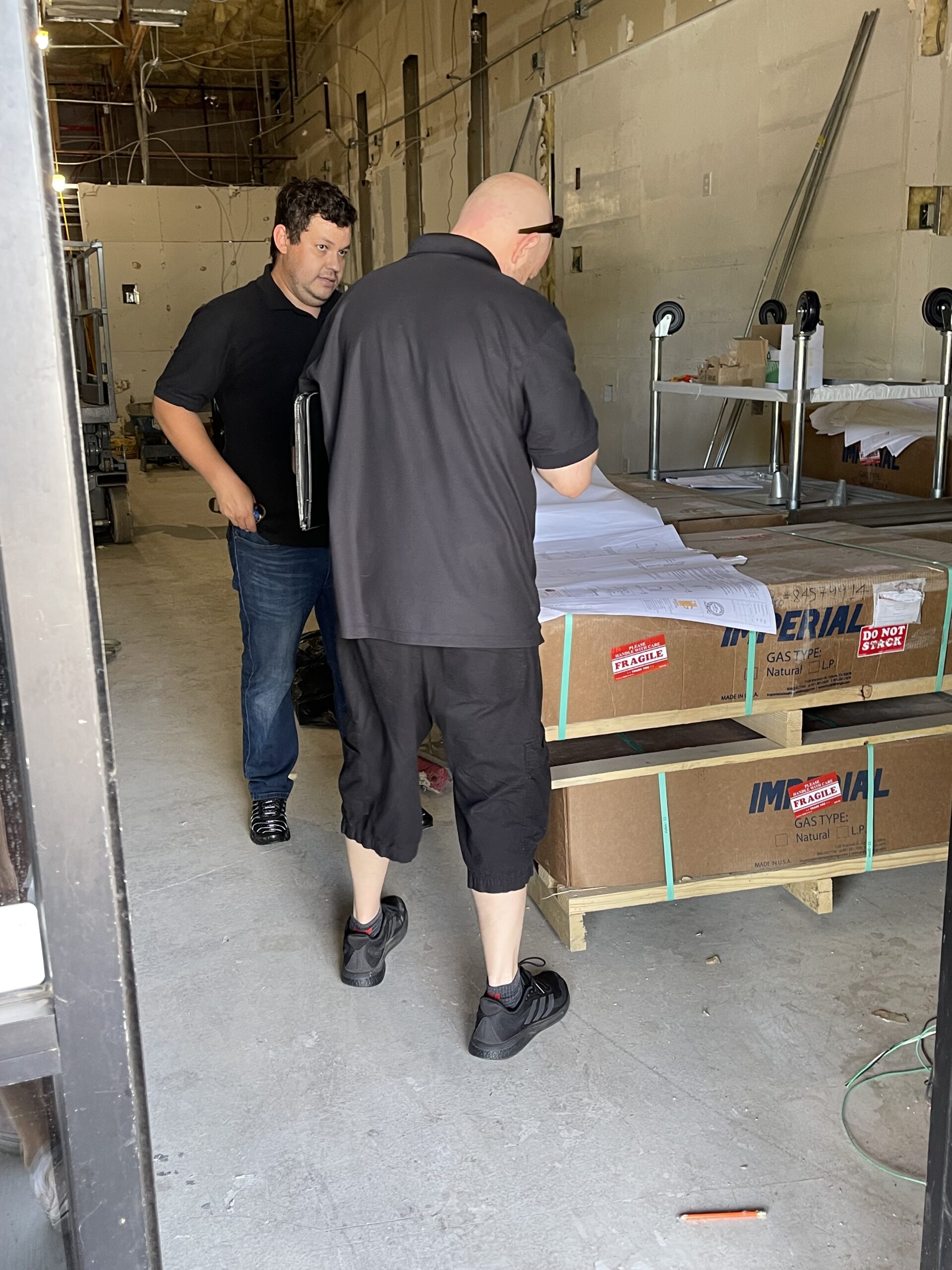 APFP associate looks through jobsite plans on a walkthrough